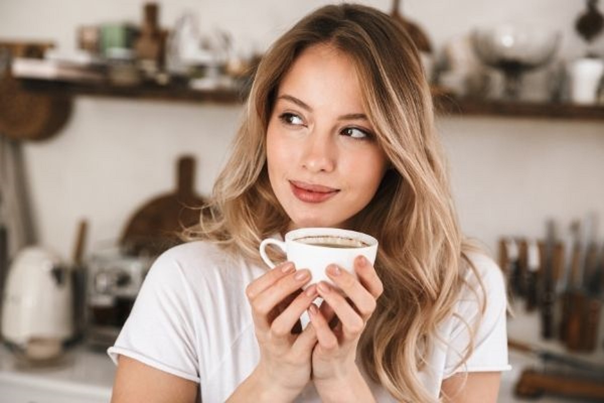 Coffee Positive woman holding a white cup